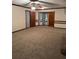 Bright living room with large windows, soft carpeting, neutral colors, and a ceiling fan at 3594 Broxton Ln, Snellville, GA 30039
