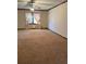 The expansive living room boasts plush carpeting, ample natural light, and neutral walls at 3594 Broxton Ln, Snellville, GA 30039