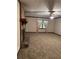 Spacious living room featuring stone fireplace, plush carpeting, ceiling fan and bright natural light at 3594 Broxton Ln, Snellville, GA 30039