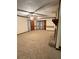 A sizable living room with a stone fireplace, neutral carpeting and an abundance of natural light at 3594 Broxton Ln, Snellville, GA 30039