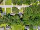 Aerial view of a black roof house surrounded by lush green trees in a residential neighborhood at 944 Pine Ridge Dr, Stone Mountain, GA 30087