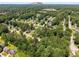 An aerial shot captures a house in a tree-filled neighborhood with nearby Stone Mountain at 944 Pine Ridge Dr, Stone Mountain, GA 30087