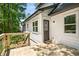 New wooden back deck with exterior access to the home, surrounded by lush greenery at 944 Pine Ridge Dr, Stone Mountain, GA 30087
