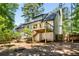 This home features a spacious backyard, partially fenced, and a small wood deck with stairs at 944 Pine Ridge Dr, Stone Mountain, GA 30087
