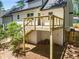 This home features a spacious backyard, partially fenced, and a small wood deck with stairs at 944 Pine Ridge Dr, Stone Mountain, GA 30087