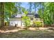 This home features a spacious backyard, partially fenced, and a small wood deck with stairs at 944 Pine Ridge Dr, Stone Mountain, GA 30087