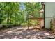 This home features a spacious backyard, partially fenced, and a small wood deck with stairs at 944 Pine Ridge Dr, Stone Mountain, GA 30087