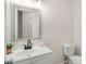 Bright bathroom with a new-looking sink and fixture, toilet, and a wall mirror at 944 Pine Ridge Dr, Stone Mountain, GA 30087