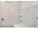 Bright bathroom with a new-looking shower-tub combo and a white door at 944 Pine Ridge Dr, Stone Mountain, GA 30087