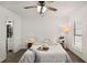 Bright bedroom featuring wood floors, a ceiling fan, and a comfortable bed with stylish decor at 944 Pine Ridge Dr, Stone Mountain, GA 30087