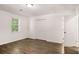 Bright bedroom featuring wood floors, a closet, and a sunlit window at 944 Pine Ridge Dr, Stone Mountain, GA 30087