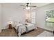 Bright bedroom featuring a ceiling fan, a large window, and a comfortable bed at 944 Pine Ridge Dr, Stone Mountain, GA 30087