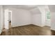 Bright bedroom featuring wood floors, a window, and access to a bathroom at 944 Pine Ridge Dr, Stone Mountain, GA 30087
