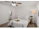Bright bedroom featuring a ceiling fan, a large window, and a comfortable bed at 944 Pine Ridge Dr, Stone Mountain, GA 30087