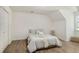 Neutral bedroom featuring wood floors, a closet, and a comfortable bed with stylish decor at 944 Pine Ridge Dr, Stone Mountain, GA 30087