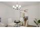 Open dining room showcases a modern light fixture, table and chairs overlooking the living room at 944 Pine Ridge Dr, Stone Mountain, GA 30087