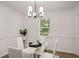 Bright dining room features a modern light fixture, table with chairs and hardwood floors at 944 Pine Ridge Dr, Stone Mountain, GA 30087