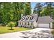 Inviting exterior of a bright Cape Cod-style home with a well-maintained lawn and attached garage at 944 Pine Ridge Dr, Stone Mountain, GA 30087