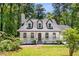 Charming Cape Cod style home featuring dormer windows, a covered front porch, and a landscaped front yard at 944 Pine Ridge Dr, Stone Mountain, GA 30087