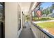 A covered porch with a view of an American flag waving by the landscaped front yard at 944 Pine Ridge Dr, Stone Mountain, GA 30087