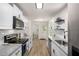 Updated kitchen features white cabinets, granite counters, stainless appliances, and modern hardware at 944 Pine Ridge Dr, Stone Mountain, GA 30087