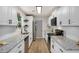 Updated kitchen features white cabinets, granite counters, stainless appliances, and modern hardware at 944 Pine Ridge Dr, Stone Mountain, GA 30087