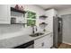 Updated kitchen features white cabinets, granite counters, stainless appliances, and modern hardware at 944 Pine Ridge Dr, Stone Mountain, GA 30087