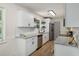 Updated kitchen features white cabinets, granite counters, stainless appliances, and modern hardware at 944 Pine Ridge Dr, Stone Mountain, GA 30087