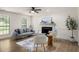Bright living room boasts a cozy seating area and hardwood floors and plenty of natural light at 944 Pine Ridge Dr, Stone Mountain, GA 30087