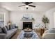 Comfortable living room features neutral walls, a modern ceiling fan, and stylish furniture at 944 Pine Ridge Dr, Stone Mountain, GA 30087