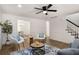 Bright living room showcases a ceiling fan and hardwood floors and abundant natural light at 944 Pine Ridge Dr, Stone Mountain, GA 30087