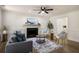 Cozy living room features a decorative fireplace, ceiling fan, and hardwood floors at 944 Pine Ridge Dr, Stone Mountain, GA 30087