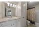 Well-lit bathroom featuring a vanity with sink, mirror, and shower-tub combination at 4106 Chastain Park Ne Ct, Atlanta, GA 30342
