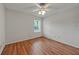 Bright bedroom with wood floors, ceiling fan, and natural light from the window at 4106 Chastain Park Ne Ct, Atlanta, GA 30342