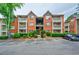 Apartment building showcasing a balcony, manicured landscaping, and reserved parking spots at 4106 Chastain Park Ne Ct, Atlanta, GA 30342
