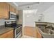 A functional kitchen with stainless steel appliances and a view to the dining room at 4106 Chastain Park Ne Ct, Atlanta, GA 30342
