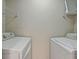 Convenient laundry area equipped with modern washer and dryer units, plus shelving at 4106 Chastain Park Ne Ct, Atlanta, GA 30342