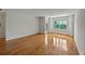 Open living room featuring hardwood floors, neutral walls, and a window bringing in natural light at 4106 Chastain Park Ne Ct, Atlanta, GA 30342