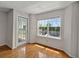 Bright living room featuring hardwood floors, neutral walls, a window, and a glass door to the outside at 4106 Chastain Park Ne Ct, Atlanta, GA 30342