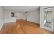Spacious living room with hardwood floors, a kitchen view, and a glass door for natural light at 4106 Chastain Park Ne Ct, Atlanta, GA 30342