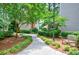 Serene walkway with lush greenery and a bench, creating a peaceful outdoor space at the building at 4106 Chastain Park Ne Ct, Atlanta, GA 30342