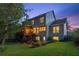 Exterior view of a two-story house with a deck, patio, and a lush green lawn at twilight at 440 Laurian Nw Way, Kennesaw, GA 30144