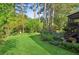 Landscaped backyard with a lawn, trees, pergola and seating areas is perfect for outdoor entertaining at 440 Laurian Nw Way, Kennesaw, GA 30144