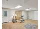 Finished basement area features an exercise area with an exercise bike and lamps at 440 Laurian Nw Way, Kennesaw, GA 30144