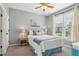 Bedroom featuring neutral carpet, light blue walls, ceiling fan, and window with curtains at 440 Laurian Nw Way, Kennesaw, GA 30144