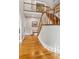 Open foyer featuring hardwood floors, a staircase with wooden railings, and neutral paint at 440 Laurian Nw Way, Kennesaw, GA 30144
