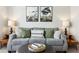 Comfortable living room featuring a gray sofa, decorative pillows, and tasteful decor at 440 Laurian Nw Way, Kennesaw, GA 30144