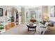 Cozy living room with large windows, plush gray couch, and access to additional rooms at 440 Laurian Nw Way, Kennesaw, GA 30144