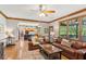 Open-concept living room with hardwood floors seamlessly connected to the kitchen and a screened-in porch at 440 Laurian Nw Way, Kennesaw, GA 30144