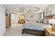 Large main bedroom featuring tray ceiling, ceiling fan, sitting area, and hardwood furniture at 440 Laurian Nw Way, Kennesaw, GA 30144